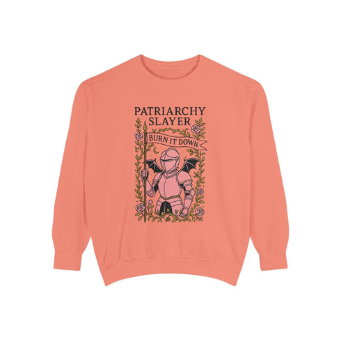 Comfort Colors garment-dyed sweatshirt featuring 'Patriarchy Slayer' design with pink armored knight holding sword and banner reading 'Burn It Down', surrounded by decorative floral border with roses and leaves. Made from 80% ring-spun cotton and 20% polyester with relaxed fit and rolled-forward shoulders. Available in lavender purple and seafoam green colorways, sizes S-3XL unisex, featuring sustainable made-to-order production with OEKO-TEX certified low-impact dyes and zero waste manufacturing process.